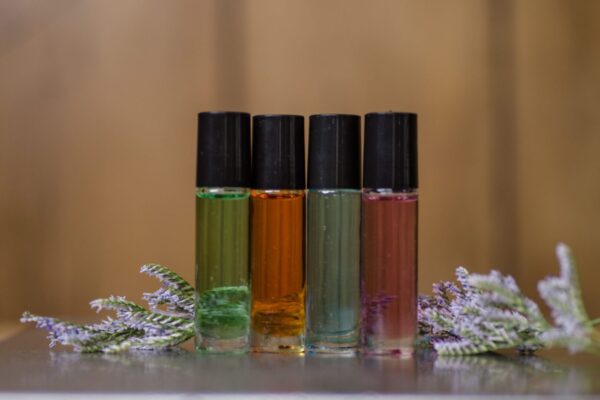 Four bottles of different colored oils sitting on a table.