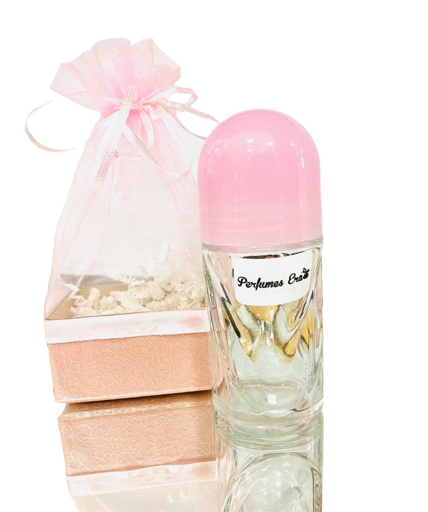 A pink and white bottle of perfume next to two boxes.